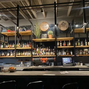 a bar with a lot of bottles on the shelves