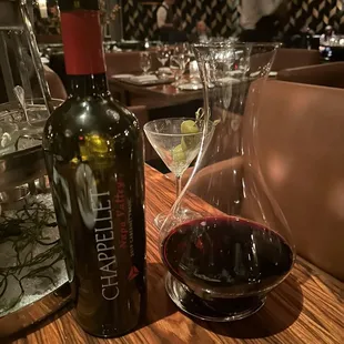 a glass of wine and a decanter