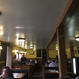 people sitting at tables in a restaurant