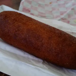 a hot dog wrapped in wax paper