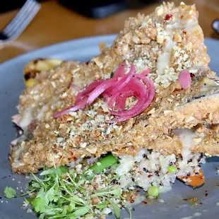 The Crispy Trout Almandine was made with almond crusted trout, carrots, snap peas, quinoa, toasted garlic chile oil, pickled red onions, beu