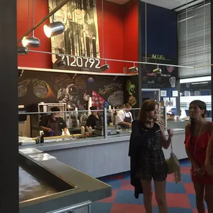 two women standing in front of the counter