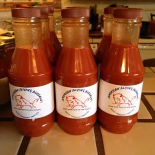 three bottles of hot sauce