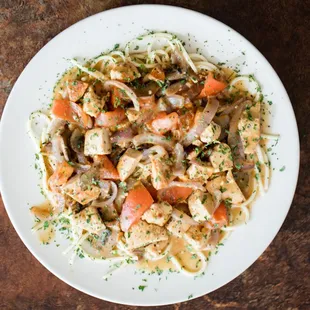 a plate of pasta with chicken and vegetables
