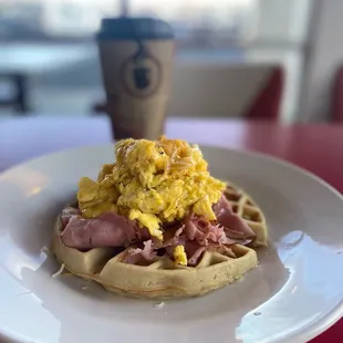 a waffle with eggs and ham