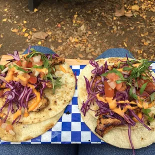 two tacos on a checkered tray