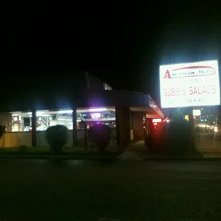 the front of the restaurant at night