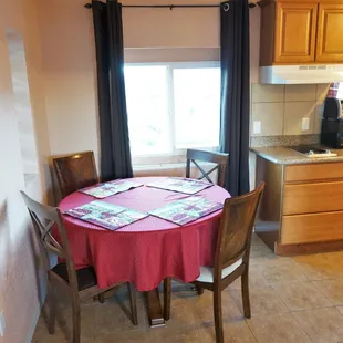 Apartment Style Suite with full size refrigerator + 2 burner cook top in kitchen, queen size bed in bedroom, and a futon in living space