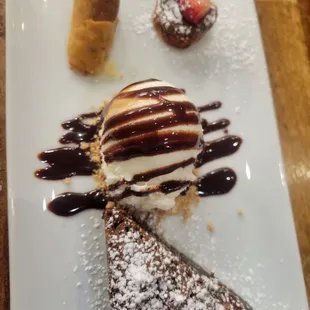a desert with ice cream and chocolate sauce