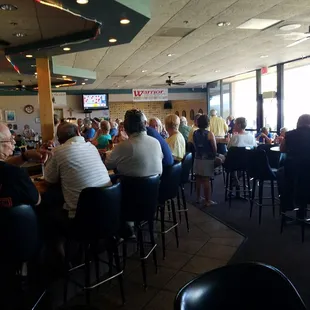 people sitting at tables in a restaurant