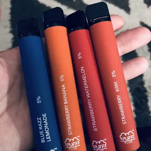 a hand holding four different colors