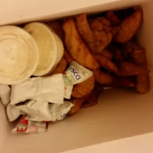 Didn't know what was in the containers.. some butter or sauce? They added ketchup on top of wedges and chicken