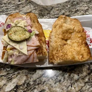 a sandwich with a pickle on the side