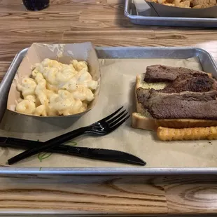 Brisket on bread with delicious Mac &amp; cheese.