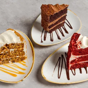 three slices of cake on plates