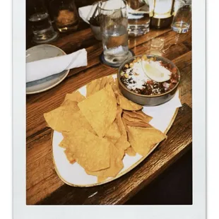 Loaded Guac (bacon, black beans, corn, pico, cotija, tortilla chips).