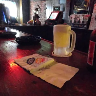 a beer and a sandwich on a bar