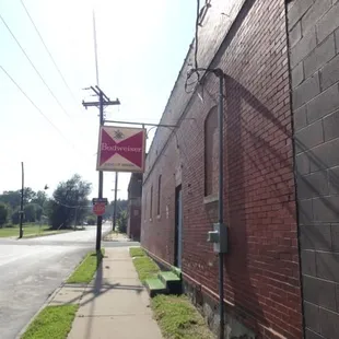 a brick building with a sign on the corner