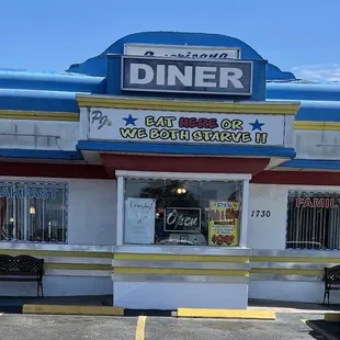 Front of business.   "EAT HERE OR WE BOTH STARVE".