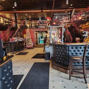 the interior of a restaurant with a christmas tree in the background