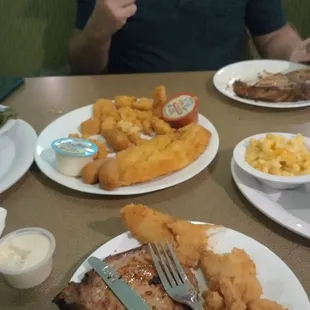 The pork chop dinner and the shrimp and flounder dinner with sides of greens, mac and cheese, broccoli casserole, and okra. Yum!