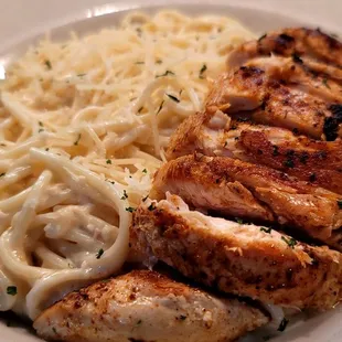 Featured Spaghetti Alfredo topped with grilled chicken. Features like this are available upon request or as advertised on facebook.