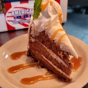 Featured carrot cake topped with housemate carmel sauce, when available.