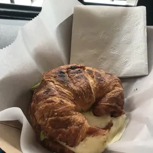 Egg whites, melted cheese, and avocado on a croissant