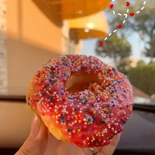 Strawberry icing donut with sprinkles