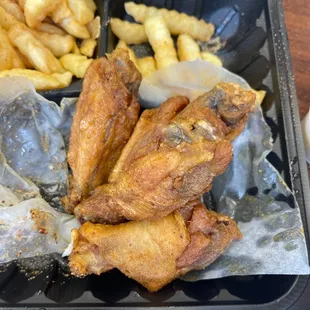 a tray of fried wings and french fries