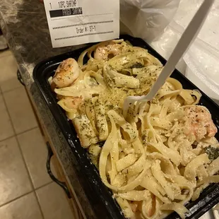 a tray of pasta and shrimp