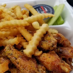 a tray of fried wings and fries