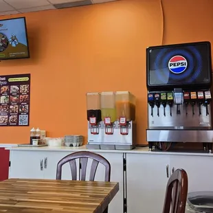 Drink fountain area and 1 of 3 tables