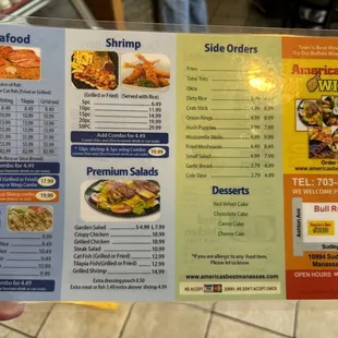 a hand holding a menu