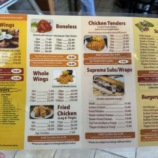 a hand holding a menu