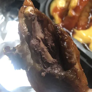 a hand holding a half eaten donut