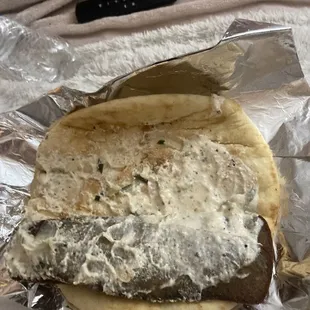 a fish sandwich wrapped in foil