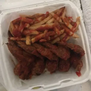 Wings and fries, salt pepper ketchup on everything