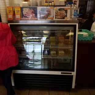 a woman standing in front of a display case