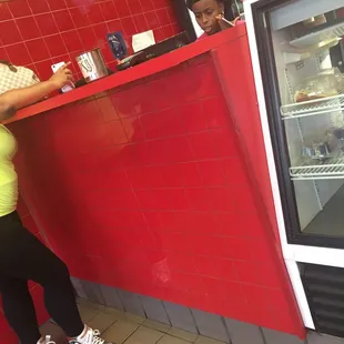 Cashier on the phone while taking customers