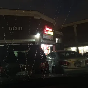 cars parked in a parking lot at night