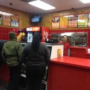 a line of people waiting at a counter