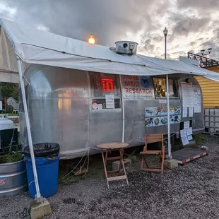 a man standing in front of a trailer