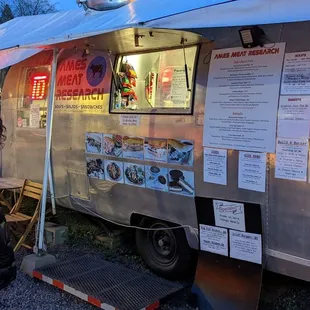 a woman standing in front of a food truck