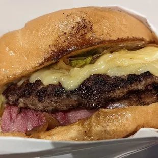 a cheeseburger in a paper container