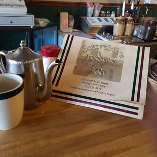 a menu and a cup of coffee