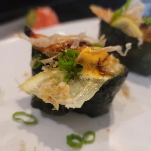 two pieces of sushi on a plate