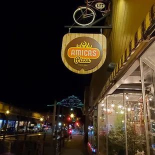 a bicyclist hanging from the sign