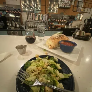 Ceasar salad, house red, chicken calzone