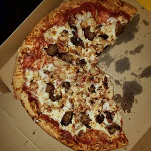a half eaten pizza in a box